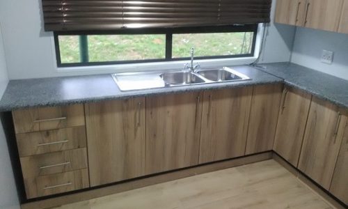 Kitchen with wooden cupboards and wooden floor